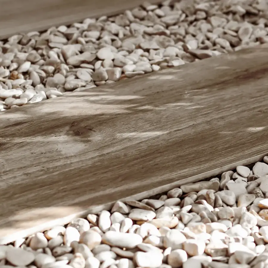 Strakke tuin met sfeervolle houten poortconstructie en buitenkeuken