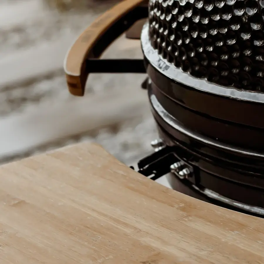 Strakke tuin met sfeervolle houten poortconstructie en buitenkeuken