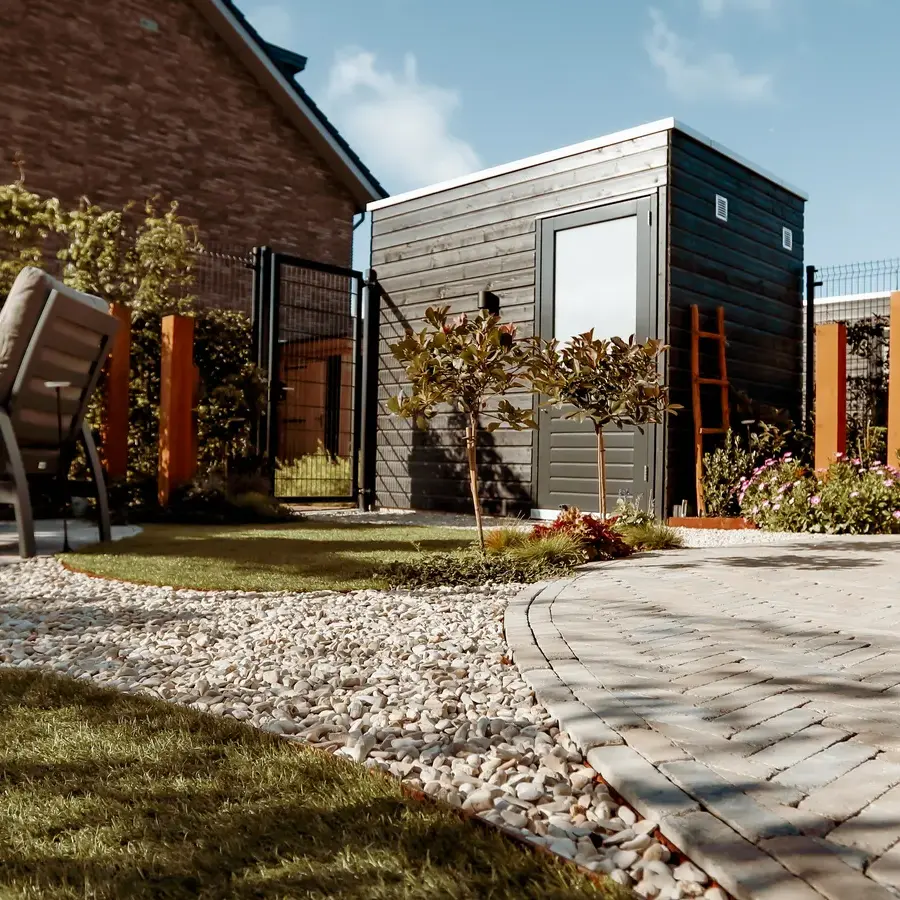 Strakke tuin met sfeervolle houten poortconstructie en buitenkeuken