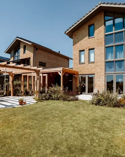 Modern landelijke tuin met Douglas overkapping en ruim gazon