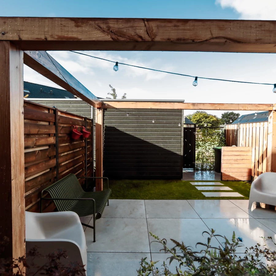 Stadstuin met middenterras, hangmat en grote pergola